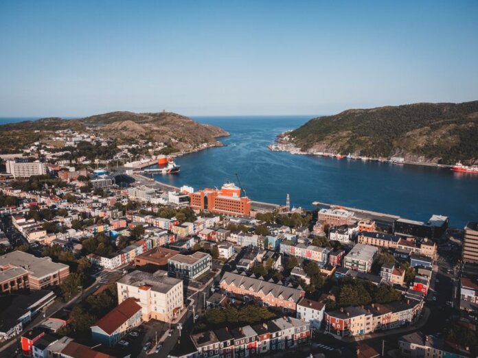 Elevated view of St. John's vibrant cityscape and picturesque harbor. Elevated view of St. John's vibrant cityscape and picturesque harbor.