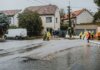 Emergency response team tackles flooding in a residential neighborhood with sandbags and preparation.