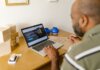 Meta запустила Muse для малого бизнеса: ИИ-агент возьмёт на себя рутину Entrepreneur at a desk using a laptop for business planning. Ideal for tech and startup themes.