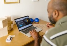 Entrepreneur at a desk using a laptop for business planning. Ideal for tech and startup themes.