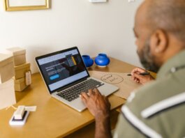 Entrepreneur at a desk using a laptop for business planning. Ideal for tech and startup themes.