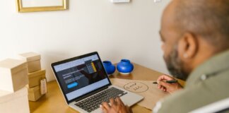 Entrepreneur at a desk using a laptop for business planning. Ideal for tech and startup themes.