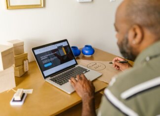 Entrepreneur at a desk using a laptop for business planning. Ideal for tech and startup themes.