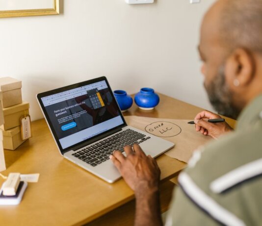 Entrepreneur at a desk using a laptop for business planning. Ideal for tech and startup themes.