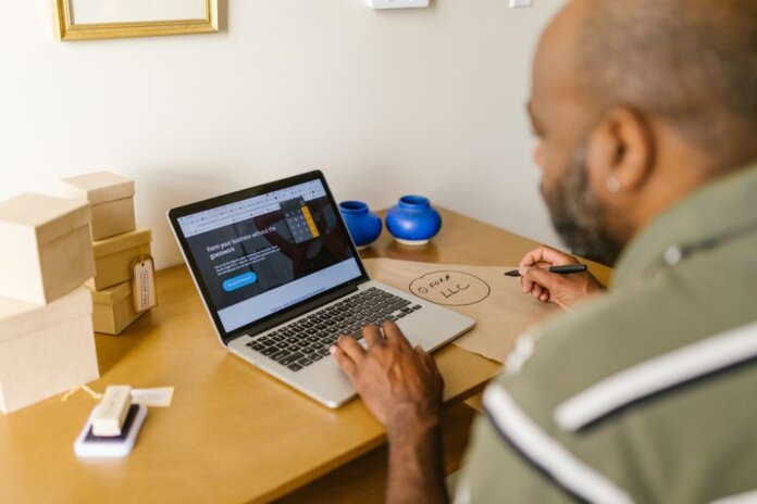Entrepreneur at a desk using a laptop for business planning. Ideal for tech and startup themes. Entrepreneur at a desk using a laptop for business planning. Ideal for tech and startup themes.