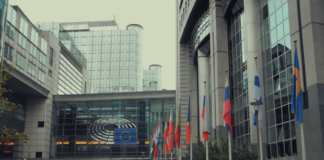 Exterior view of European Parliament with EU flags in Brussels