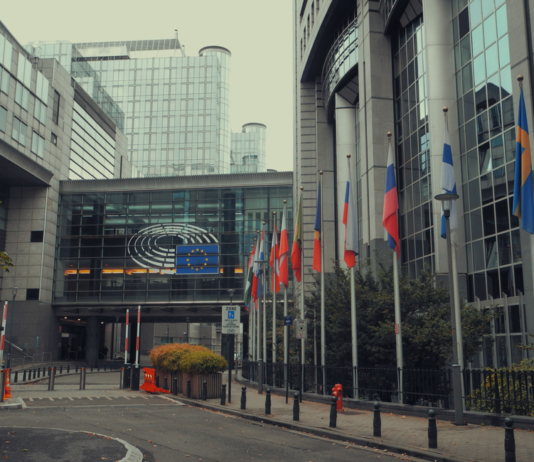Exterior view of European Parliament with EU flags in Brussels