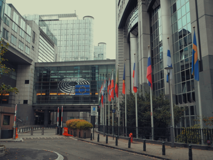 Exterior view of European Parliament with EU flags in Brussels Exterior view of European Parliament with EU flags in Brussels