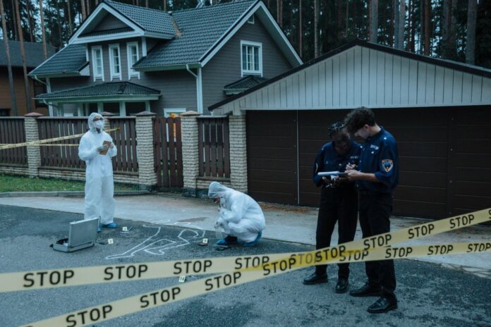 Forensic team investigates suburban crime scene with police officers and evidence markers. Forensic team investigates suburban crime scene with police officers and evidence markers.
