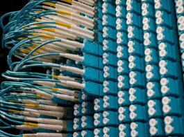 From below of fiber optic equipment with similar colorful rubber cables and round sockets