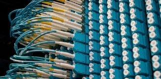 From below of fiber optic equipment with similar colorful rubber cables and round sockets