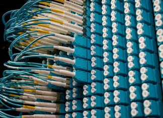 From below of fiber optic equipment with similar colorful rubber cables and round sockets