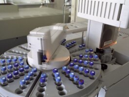 High-tech laboratory equipment with multiple vials in a scientific research facility.