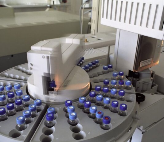 High-tech laboratory equipment with multiple vials in a scientific research facility.