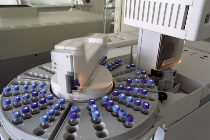 High-tech laboratory equipment with multiple vials in a scientific research facility. High-tech laboratory equipment with multiple vials in a scientific research facility.