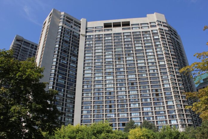 Modern high-rise residential building in Toronto under clear sky. Modern high-rise residential building in Toronto under clear sky.