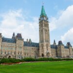 Правительство Канады выпустило новый климатический доклад Stunning photo of Canada's Parliament Hill in Ottawa under a clear sky, showcasing Gothic Revival architecture.