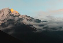 Stunning view of the Himalayan mountains in Nepal during sunrise, with cloud cover adding drama.