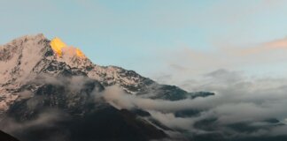 Stunning view of the Himalayan mountains in Nepal during sunrise, with cloud cover adding drama.