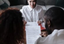 Канада поставит калий Бангладеш: новое межправительственное соглашение Three people reviewing documents in an office setting, focusing on adoption paperwork.