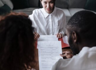Канада поставит калий Бангладеш: новое межправительственное соглашение Three people reviewing documents in an office setting, focusing on adoption paperwork.
