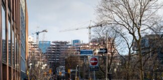 Urban construction site in downtown Toronto with cranes and modern architecture.