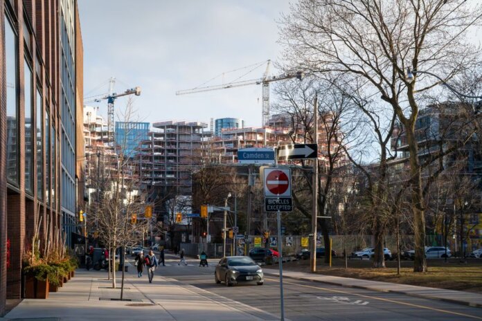 Urban construction site in downtown Toronto with cranes and modern architecture. Urban construction site in downtown Toronto with cranes and modern architecture.
