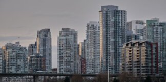 View of Vancouver's skyline featuring modern skyscrapers and boats on the water.