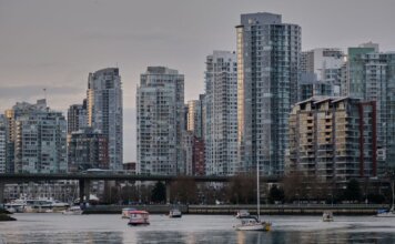 View of Vancouver's skyline featuring modern skyscrapers and boats on the water.
