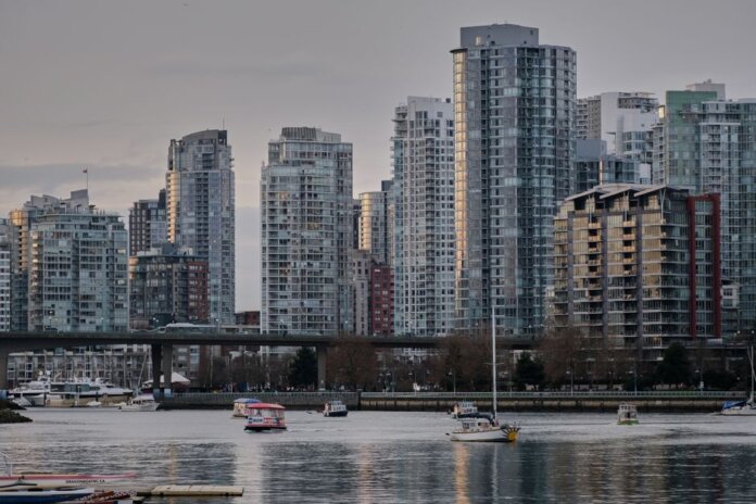 View of Vancouver's skyline featuring modern skyscrapers and boats on the water.