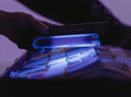 A close-up shot of banknotes under UV light to verify currency authenticity and detect counterfeits.