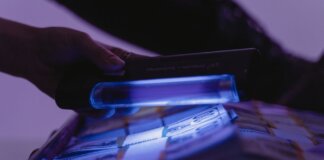 A close-up shot of banknotes under UV light to verify currency authenticity and detect counterfeits.