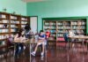 A diverse group of kids reading books in a library setting, fostering learning and togetherness.