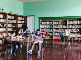 A diverse group of kids reading books in a library setting, fostering learning and togetherness.