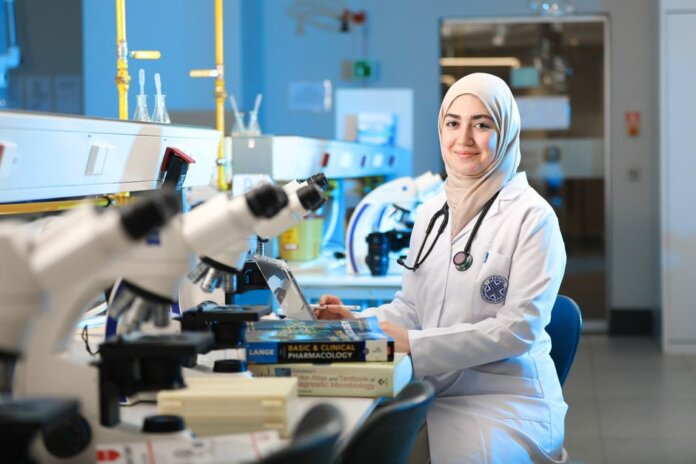 A female scientist in a laboratory setting, conducting research with microscopes and reference books. A female scientist in a laboratory setting, conducting research with microscopes and reference books.