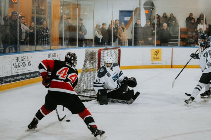 A thrilling hockey game captured indoors with players in action and spectators watching keenly. A thrilling hockey game captured indoors with players in action and spectators watching keenly.