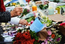 A touching scene of a memorial with flowers and candles.
