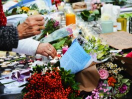 A touching scene of a memorial with flowers and candles.