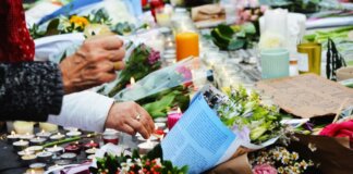 A touching scene of a memorial with flowers and candles.
