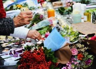 A touching scene of a memorial with flowers and candles.