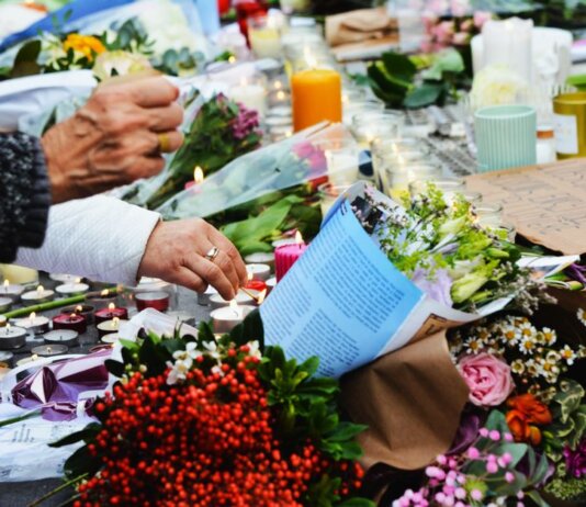 A touching scene of a memorial with flowers and candles.