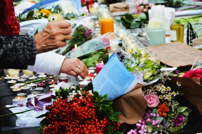 A touching scene of a memorial with flowers and candles. A touching scene of a memorial with flowers and candles.