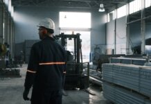 A worker in protective gear supervises operations in a modern Ankara factory.