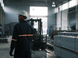 A worker in protective gear supervises operations in a modern Ankara factory.