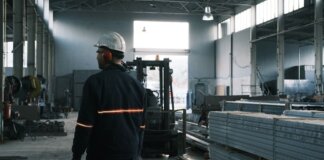 A worker in protective gear supervises operations in a modern Ankara factory.