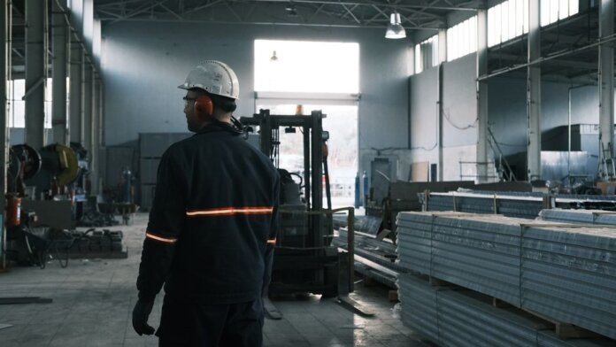 A worker in protective gear supervises operations in a modern Ankara factory. A worker in protective gear supervises operations in a modern Ankara factory.