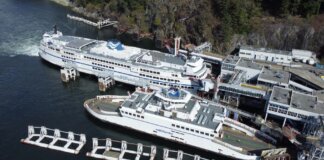 Aerial photo of large BC Ferries docked at a scenic coastal terminal