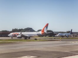Airliners taxiing on a sunny day at an airport, ready for takeoff.