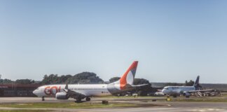 Airliners taxiing on a sunny day at an airport, ready for takeoff.