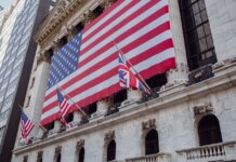 American flag on a historic building exterior symbolizing patriotism and national pride.